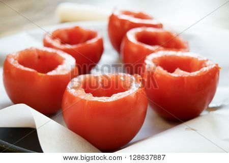 preparing tomatoes stuffed with rice with the removal of the pulp and the seeds