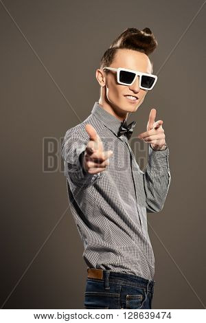 Fashion studio shot of a handsome male model with stylish hair. Male haircuts. Beauty, fashion.