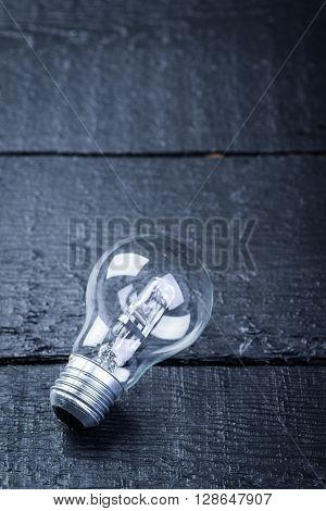Tungsten bulb on a black wooden table