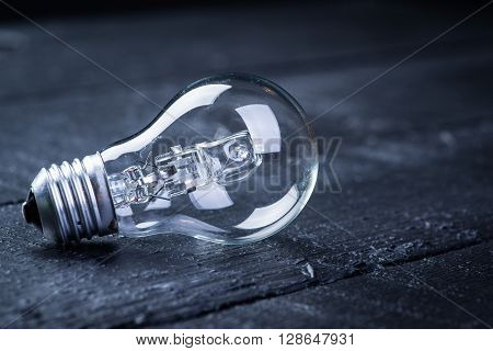 Tungsten bulb on a black wooden table