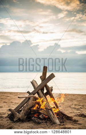 Bonfire At The Beach With Dramatic Clouds