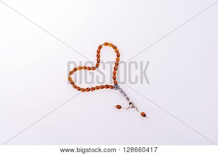 Tespih forming a heart on a white background