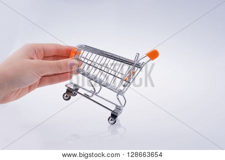 Hand holding a Cart on a white background