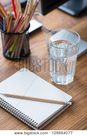 Light And Cozy Workplace With Glass Of Water