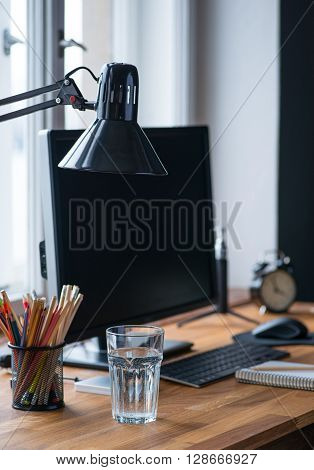 Light And Cozy Workplace With Glass Of Water