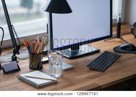 Light And Cozy Workplace With Glass Of Water