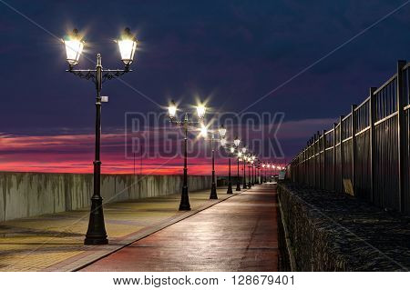 Nizhneimeretinskaya embankment with glowing lanterns and bicycle path Sochi Russia HDR processing