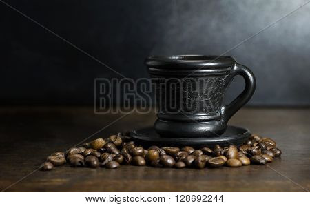 A cup of hot coffee on wooden background