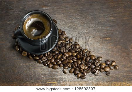 A cup of hot coffee on wooden background
