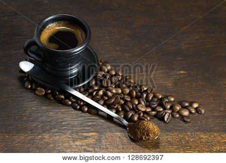 A cup of hot coffee on wooden background