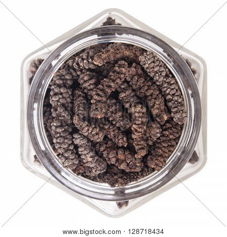 long pepper  in glass bottle, isolated on white background