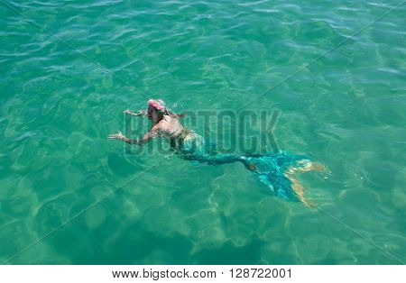 COOGEE,WA,AUSTRALIA-APRIL 3,2016: Live interactive mermaid entertainer swimming in the Indian Ocean at the Coogee Beach Festival in Coogee, Western Australia.