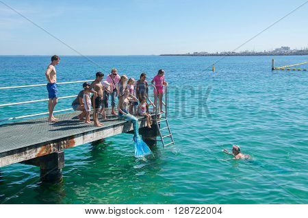 COOGEE,WA,AUSTRALIA-APRIL 3,2016: Live interactive mermaids entertainers with families at the Coogee Beach Festival in Coogee, Western Australia.