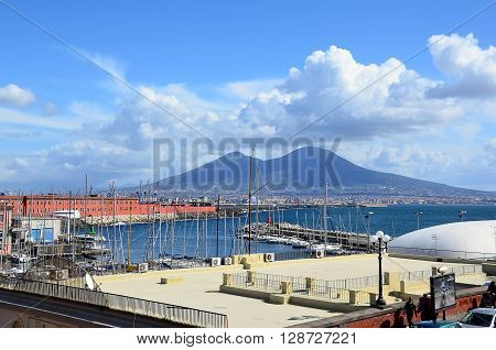 landscape with Naples city harbor and Vesuvius volcano in centre of background