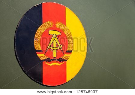 GRIMMEN/ GERMANY - MAY 1: German Democratic Republic emblem on green background on may 5 2016 in Grimmen / Germany.