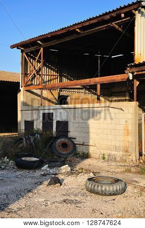 Ruined ramshackle hangar in abandoned industrial  zone.