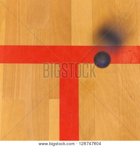 black squash ball on the sqash court