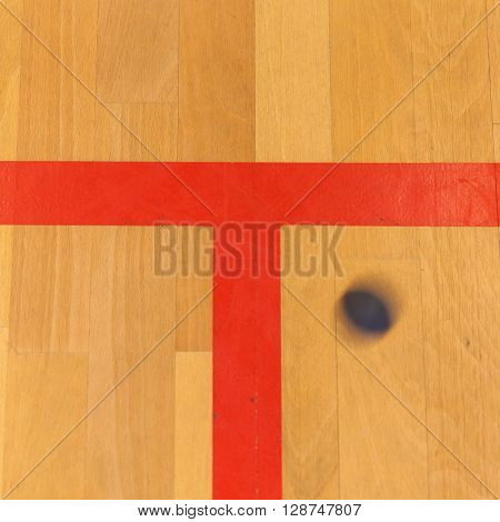 black squash ball on the sqash court
