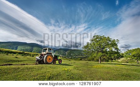 ?ractor digging a channel for drainage of water in the mountains!