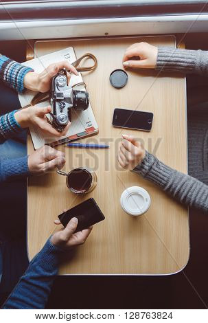 Among friends, sitting at a table taking pictures. top view
