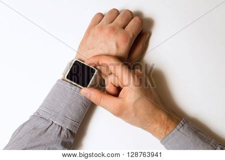 smart watch on a male hand on white background. Mock up. Top view