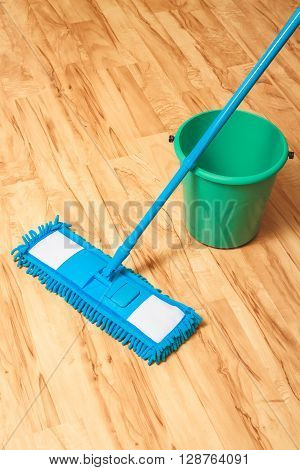 A bucket of water and mop. Wash wood floor concept