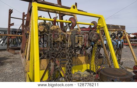 Electrical block and tackles with chains and hooks haning on a scaffolding