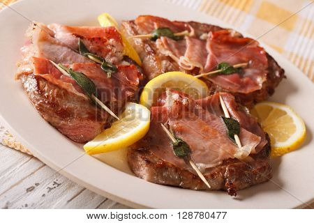 Italian Cuisine: Beef Saltimbocca With Lemon Close Up. Horizontal
