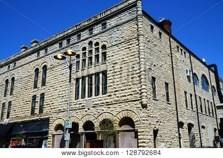 JOLIET, ILLINOIS / UNITED STATES - APRIL 26, 2015:  A lamppost stands in front of the former Saint John's Universalist Church in downtown Joliet.