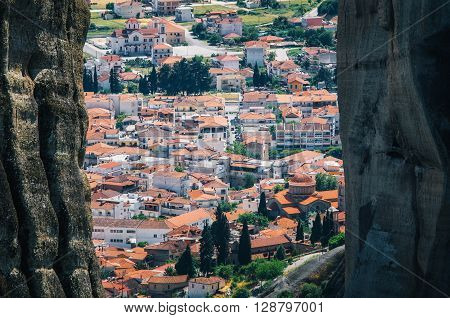 View of the red roofs of the town of Kalambaka buildings through the rocks from the Meteora rocks Greece