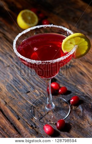 Cosmopolitan cocktail top on bar, cocktail made with vodka, triple sec, cranberry juice, and freshly squeezed lime juice or sweetened lime juice.