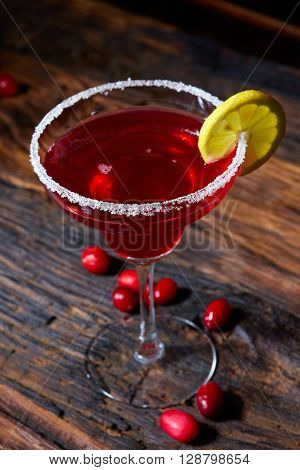 Cosmopolitan cocktail top on bar, cocktail made with vodka, triple sec, cranberry juice, and freshly squeezed lime juice or sweetened lime juice.