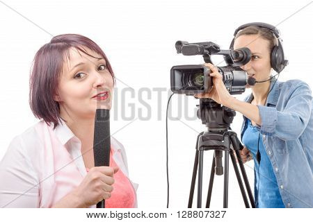 a young woman journalist with a microphone and camerawoman