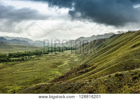Sayansk mountains on the way to the city of Kyzyl in an environment of storm clouds.