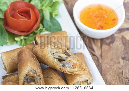 Spring roll vietnamese cuisine in Thai style with sweet suace on wooden table