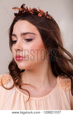 Portrait of a gorgeous brunette on a light background. Chic hair eyes and eyebrows.