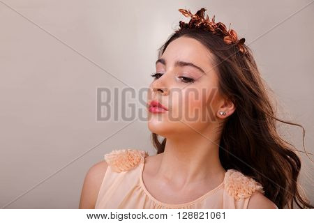 Portrait of a gorgeous brunette on a light background. Chic hair eyes and eyebrows.