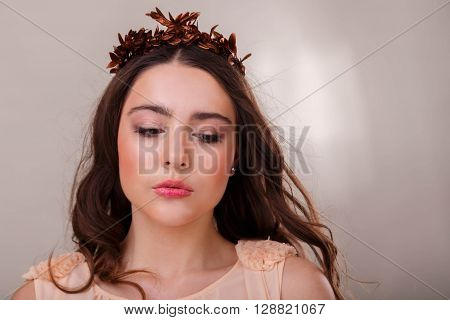 Portrait of a gorgeous brunette on a light background. Chic hair eyes and eyebrows.