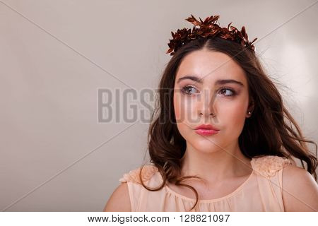 Portrait of a gorgeous brunette on a light background. Chic hair eyes and eyebrows.