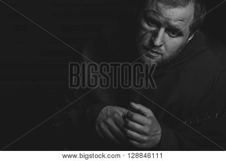 Beautiful and fascinating game theater actor on camera. Black and white photo of the actor in the guise of a beggar on a dark background. Beautifully decorated stage image and professional makeup.