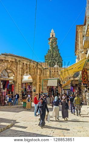 JERUSALEM ISRAEL - FEBRUARY 18 2016: The market street leading to the Church of the Holy Sepulchre and the Gate of the Aftimos Bazaar from the left on February 18 in Jerusalem.