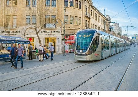 JERUSALEM ISRAEL - FEBRUARY 18 2016: The light rail train rides in Yafo Road the noisy shopping street on February 18 in Jerusalem.