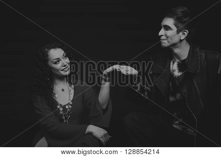 Acting. Man and woman in an interesting way on a dark background.