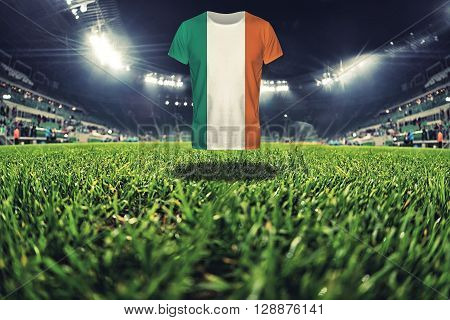 Ireland national flag on t-shirt on football stadium, greem grass