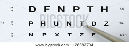 Silver Ballpoint Pen Pointing To Letter In Eyesight Check Table