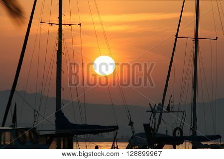 sunset at harbour with boats at sea