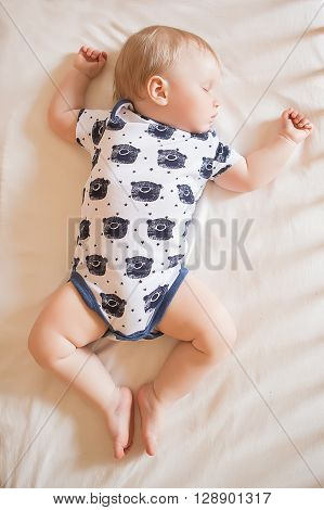 Peaceful adorable baby sleeping on his bed in a room. Soft focus. Sleeping baby concept. year-old babyboy sleeps at home