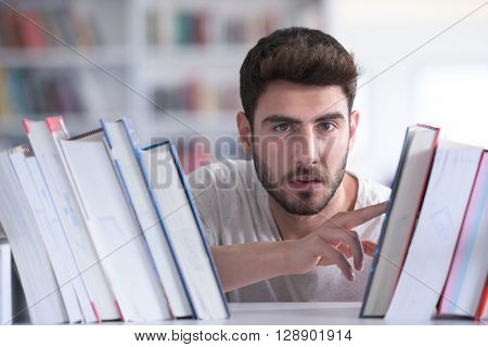 Student reading book in school library. Study lessons for exam. Hard worker and persistance concept.