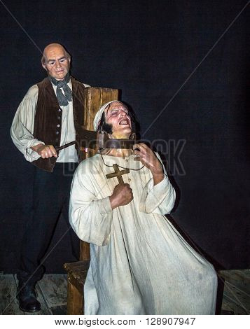 LONDON UK - JUNE 7 2015: The executioner and the scene of the execution of strangulation  at one of halls of historical part of Madame Tussauds wax museum. Madame Tussauds London is famous for recreating famous people and celebrities in wax.