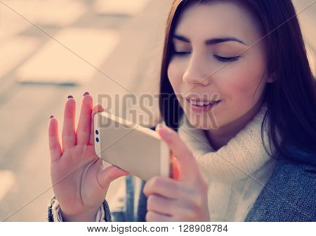Young Girl Taking Photo On Her Smart Phone